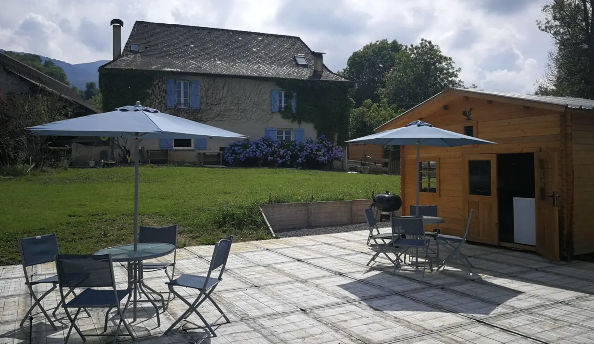 La terrasse, ses parasols et le chalet en bois